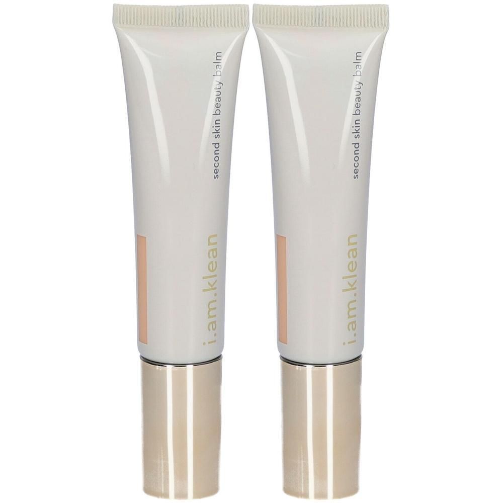 Twee tubes i.am.klean Second Skin Beauty Balm in perziktint met gouden doppen.