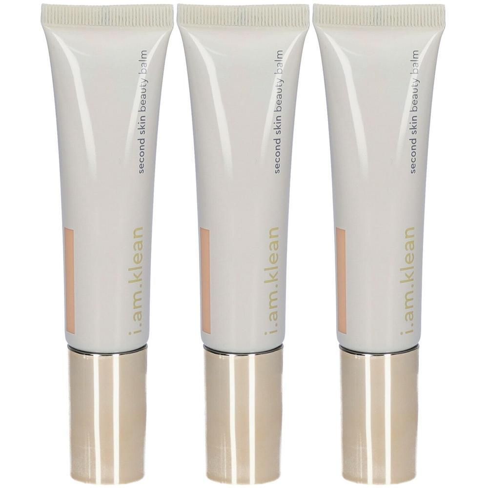 Drie tubes i.am.klean Second Skin Beauty Balm in perziktint met gouden doppen.
