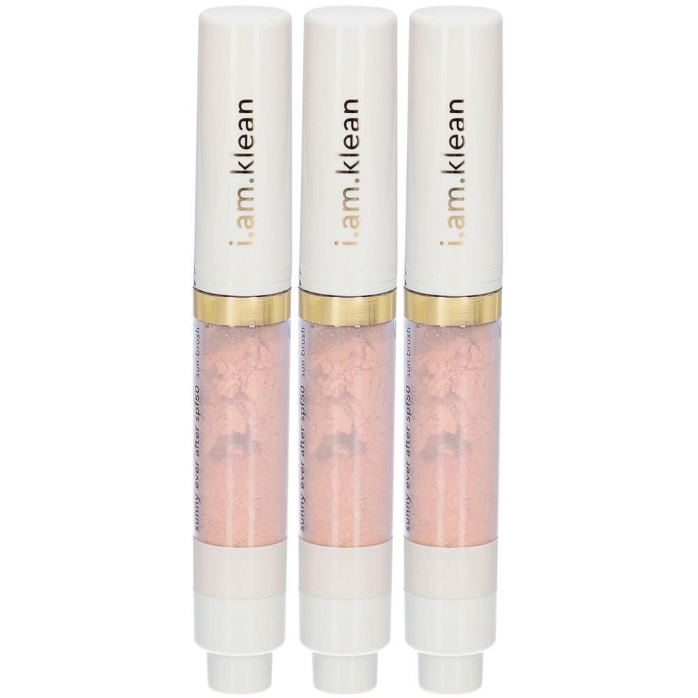 Drie i.am.klean zonneborstel-applicators met witte dop en gouden ring, gevuld met roze poeder.