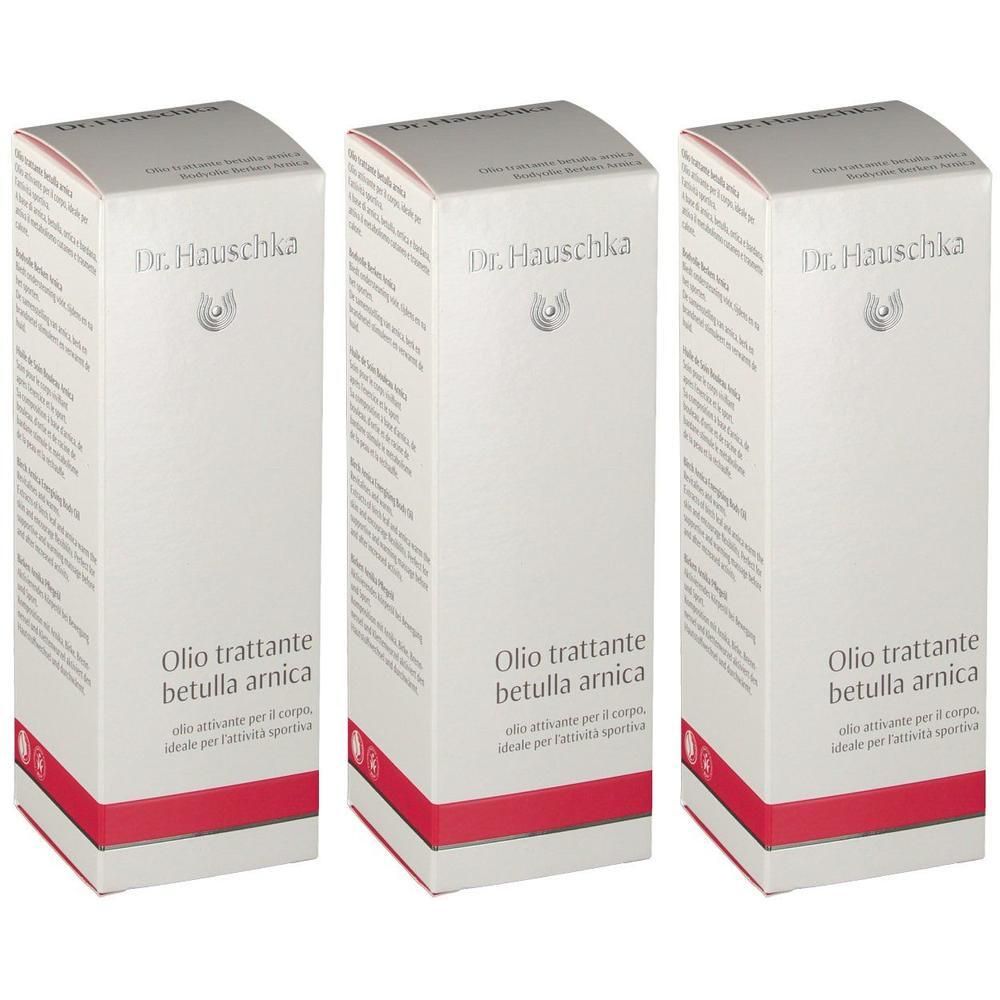 Trois boîtes d'huile corporelle Bouleau Arnica Dr. Hauschka, blanches avec des accents rouges.