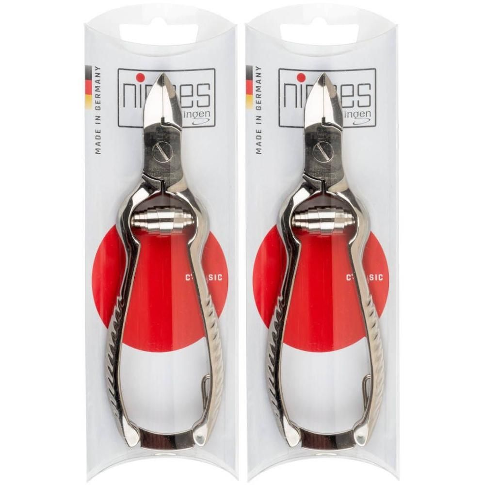 Deux coupe-ongles en métal sous emballage transparent. Partie supérieure avec logo "nippes" et "Made in Germany".