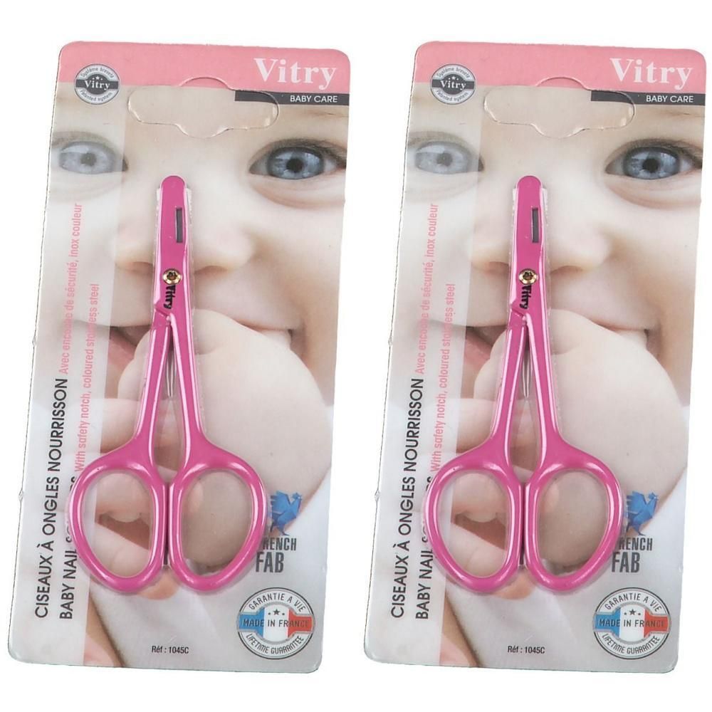 Deux ciseaux roses pour bébé en inox, pastel, emballage avec visage de bébé.