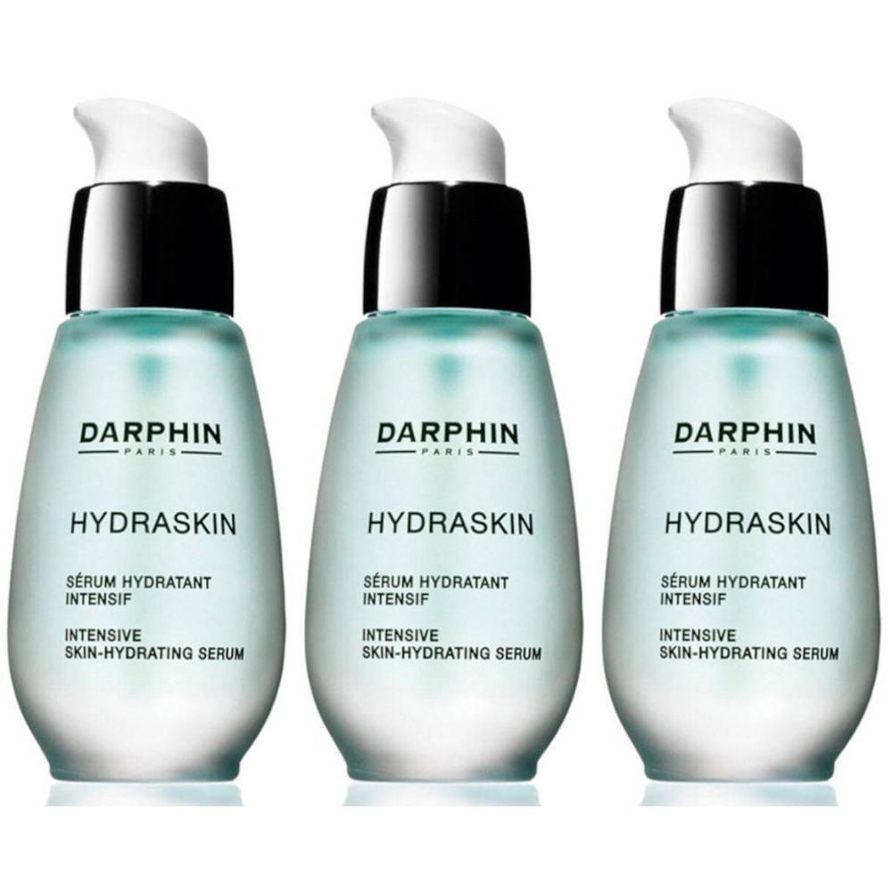 Trois flacons Darphin Hydraskin avec pompes. Liquide bleu clair dans des flacons transparents.