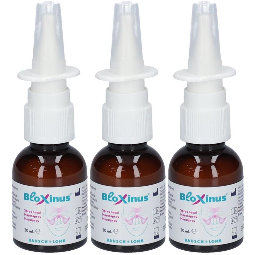 Trois flacons de spray nasal en verre brun avec têtes de pulvérisation blanches et capuchons transparents. Étiquette : BloXinus, 20 ml, Bausch + Lomb.