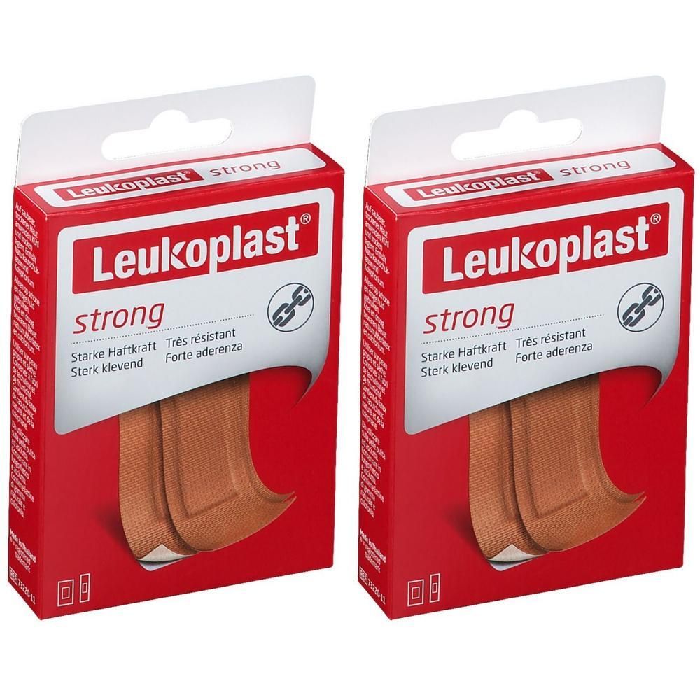 Deux paquets de pansements Leukoplast Strong. Emballage carton rouge avec fenêtre transparente montrant deux pansements couleur chair.