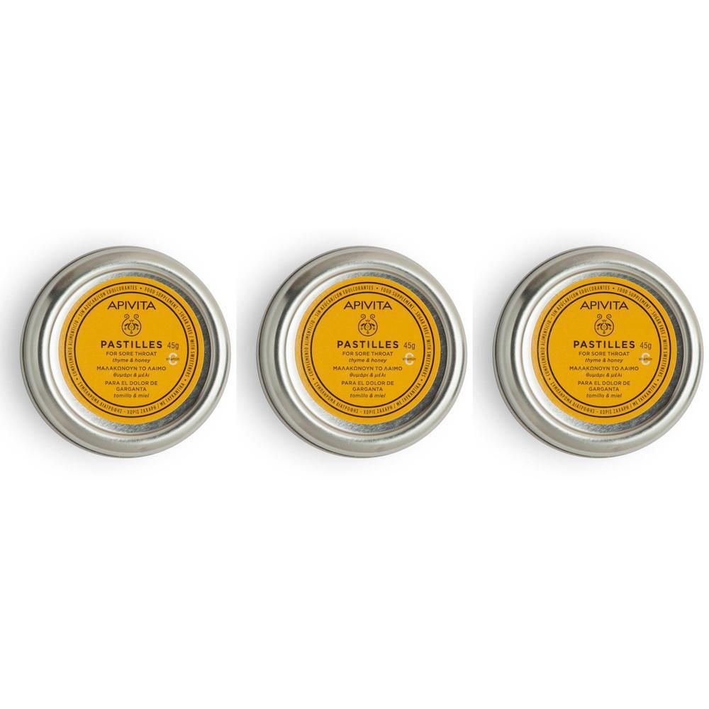 Drie ronde metalen blikjes met gele etiketten, met APIVITA Pastilles Tijm & Honing.