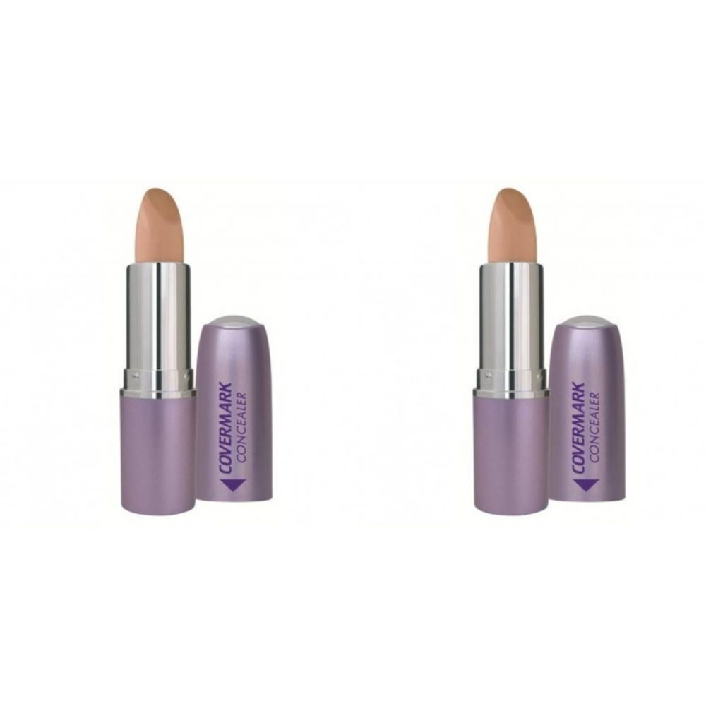 Deux bâtons de correcteur Covermark, teinte chair claire, avec corps argenté et capuchon violet.