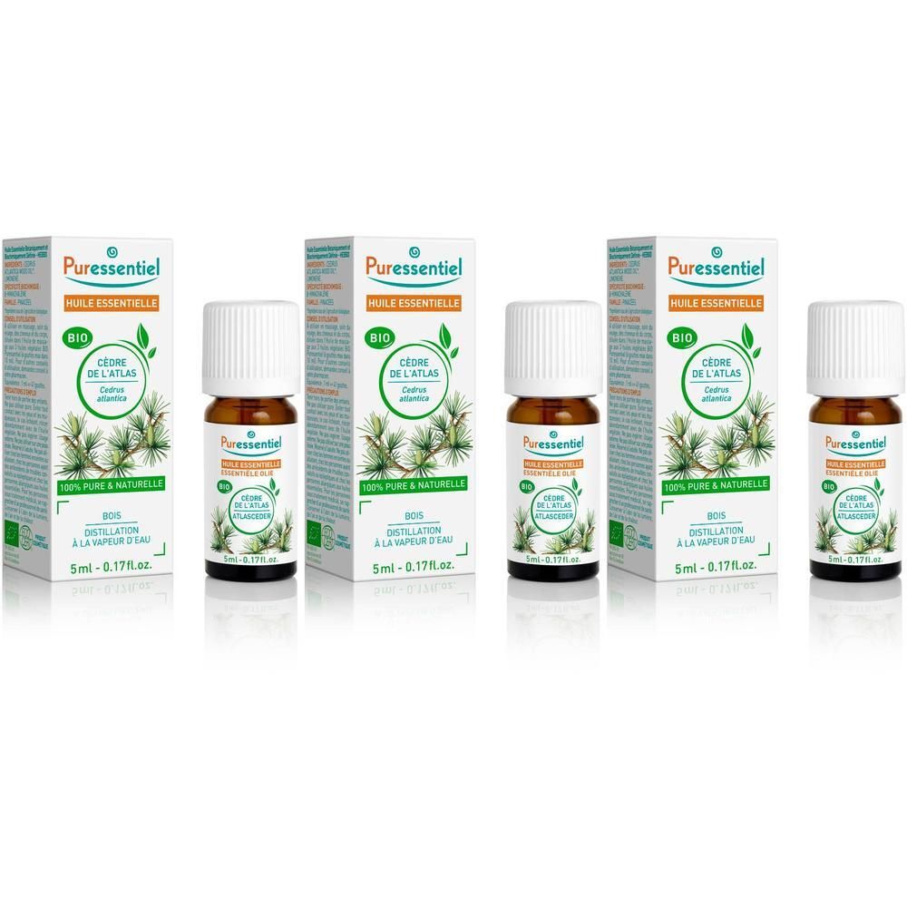 Huile essentielle bio Puressentiel Cèdre Atlas en flacons de verre brun avec bouchons blancs, présentés en boîtes.