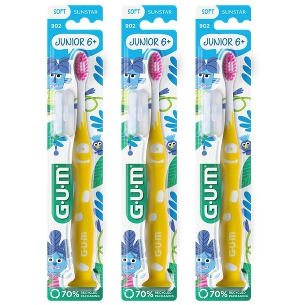 Trois brosses à dents GUM Junior 7-9 ans jaunes avec poils roses, emballées individuellement.