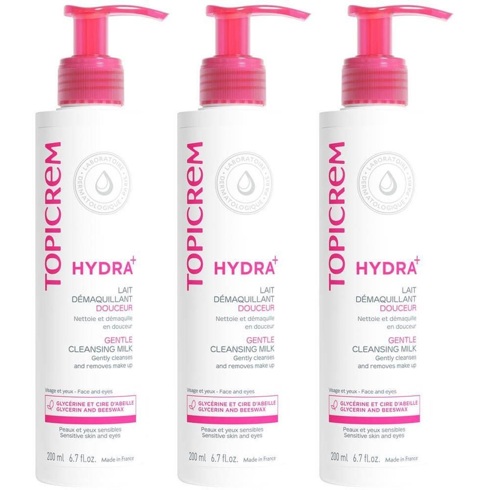 Drie flessen Topicrem Gentle Cleansing Milk met roze pompkopjes. Witte flessen met roze en grijze belettering.