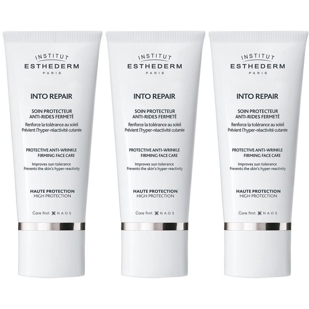 Drie witte tubes Institut Esthederm Into Repair gezichtscreme. Hoge zonbescherming.