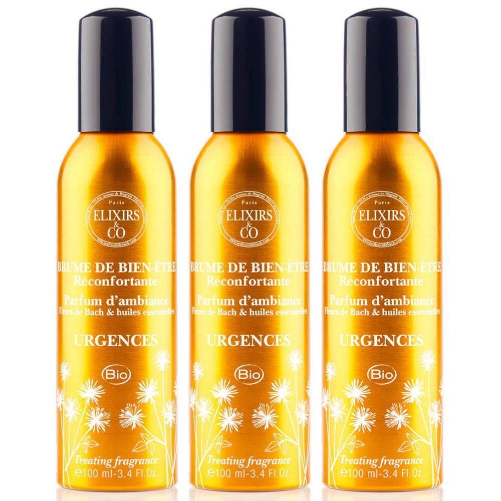 Trois flacons dorés à tête noire, ornés de fleurs blanches et du texte "Elixirs & Co Urgences Bio".