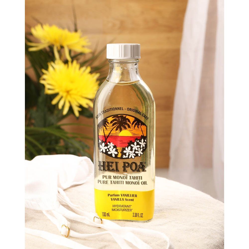 Un flacon d'huile de Monoï HEI POA parfum Vanille dans un décor de bien-être.