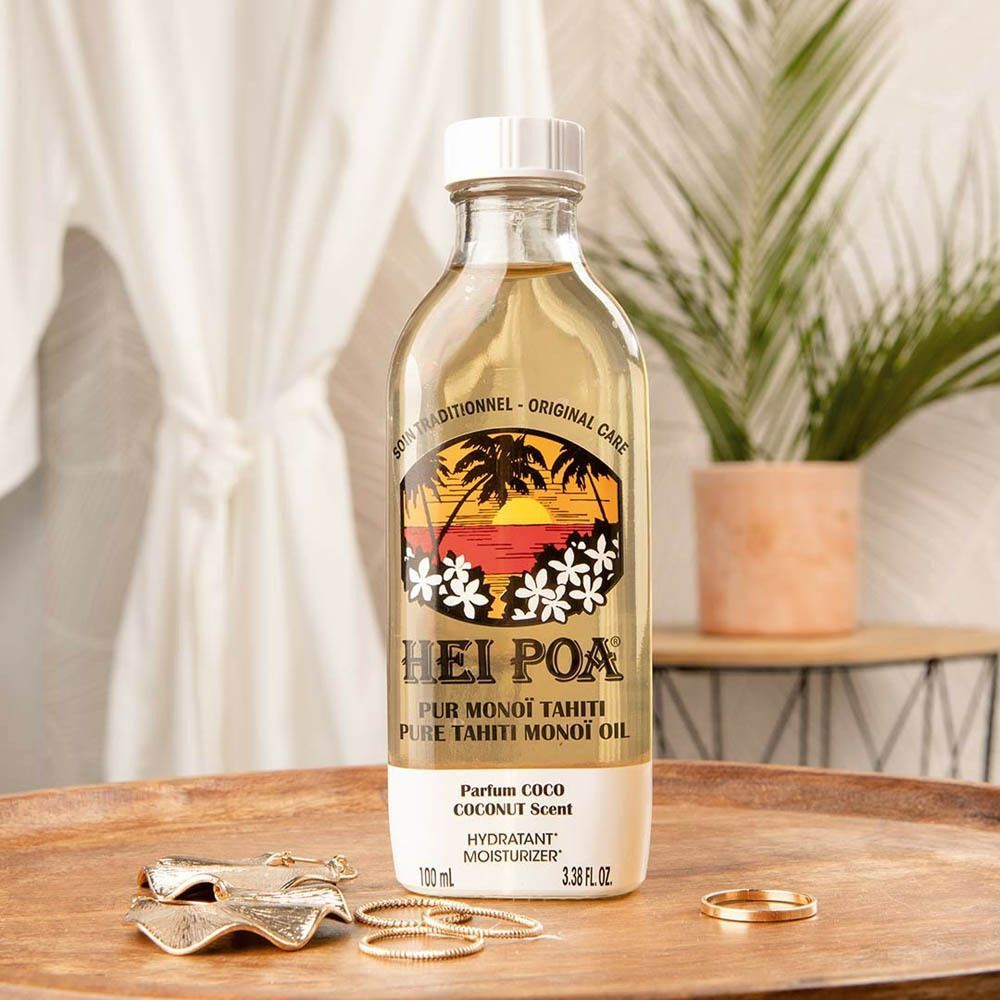 Un flacon d'Huile Hei Poa Pur Monoï Tahiti Parfum Coco sur un plateau.