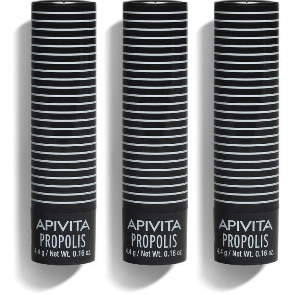 Trois sticks à lèvres Apivita Propolis, corps noir à rayures blanches. Poids net 0.16 oz.