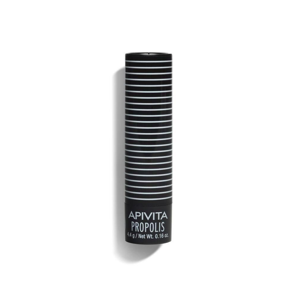 Stick à lèvres Apivita Propolis dans un tube noir à rayures blanches.