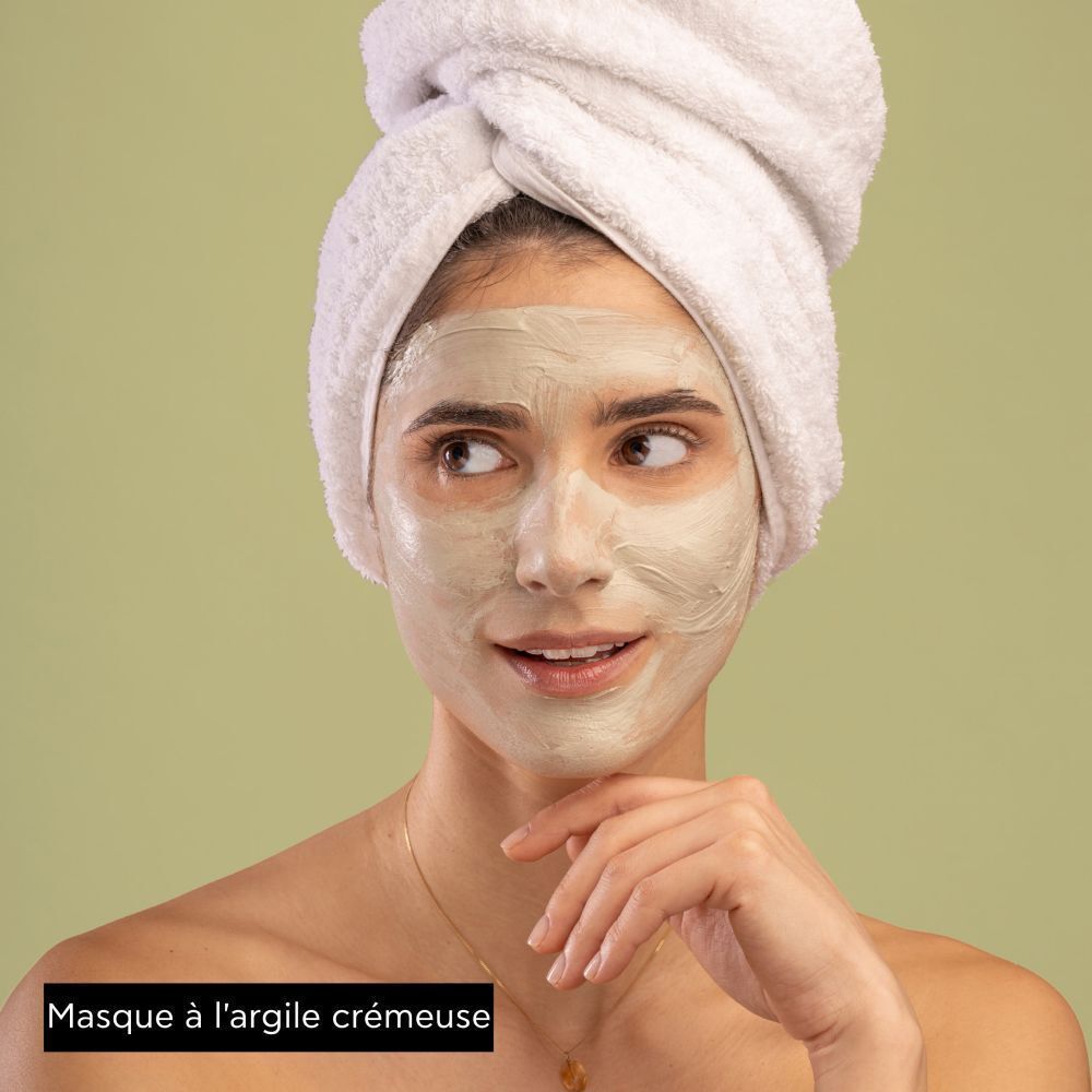 Femme portant un masque visage Apivita à l'argile verte.