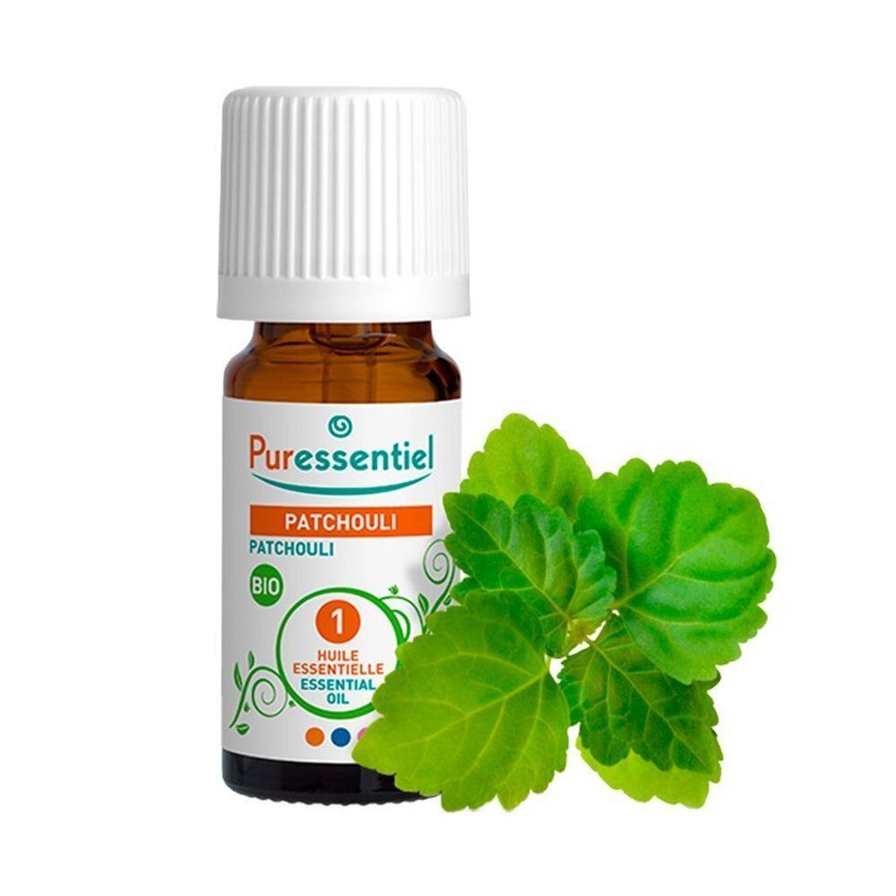 Flacon d'huile essentielle de Patchouli Bio Puressentiel avec des feuilles vertes.