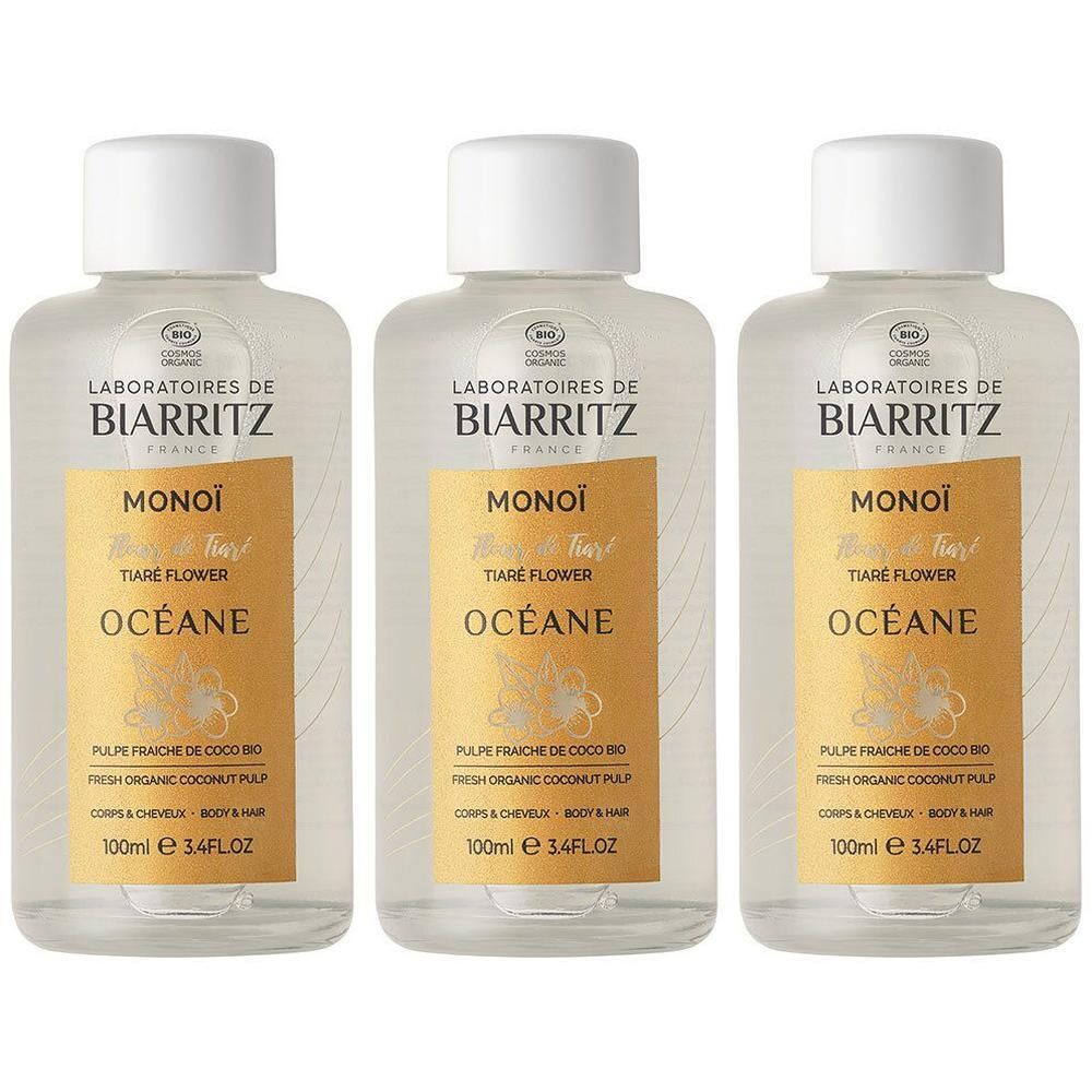 Drie flessen Laboratoires de Biarritz Monoi Tiaré Flower Océane olie. Heldere vloeistof in transparante flessen met witte doppen.