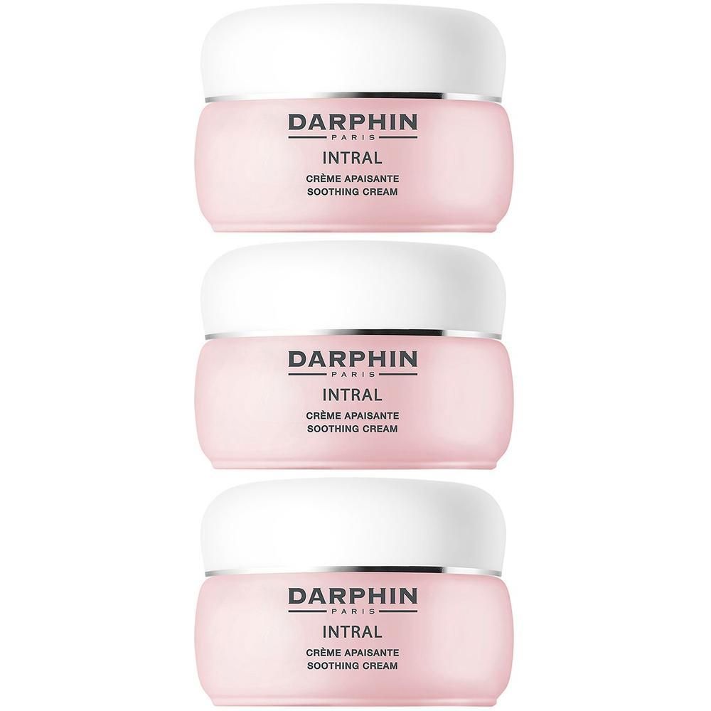Trois pots de crème apaisante Darphin Intral avec couvercle blanc et bande argentée.