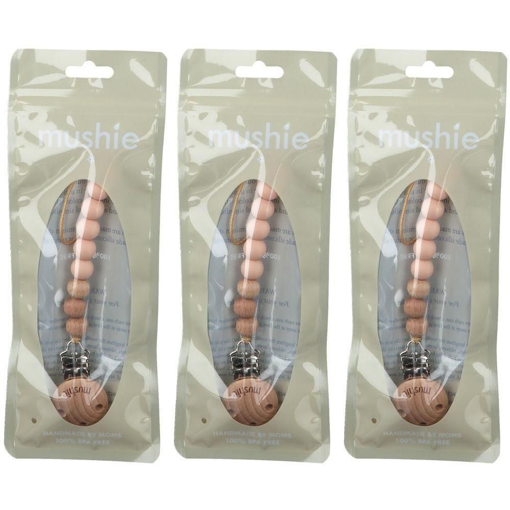 Drie Mushie fopspeenkoorden met roze houten kralen, elk in een doorzichtige verpakking.