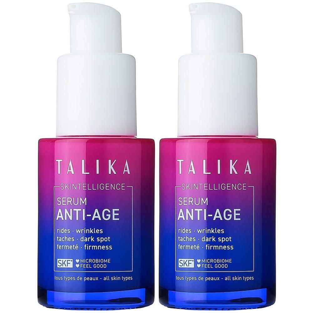 Deux flacons de Talika Skintelligence Sérum Anti-Âge avec pompes. Dégradés de couleur violet-bleu sur les flacons.