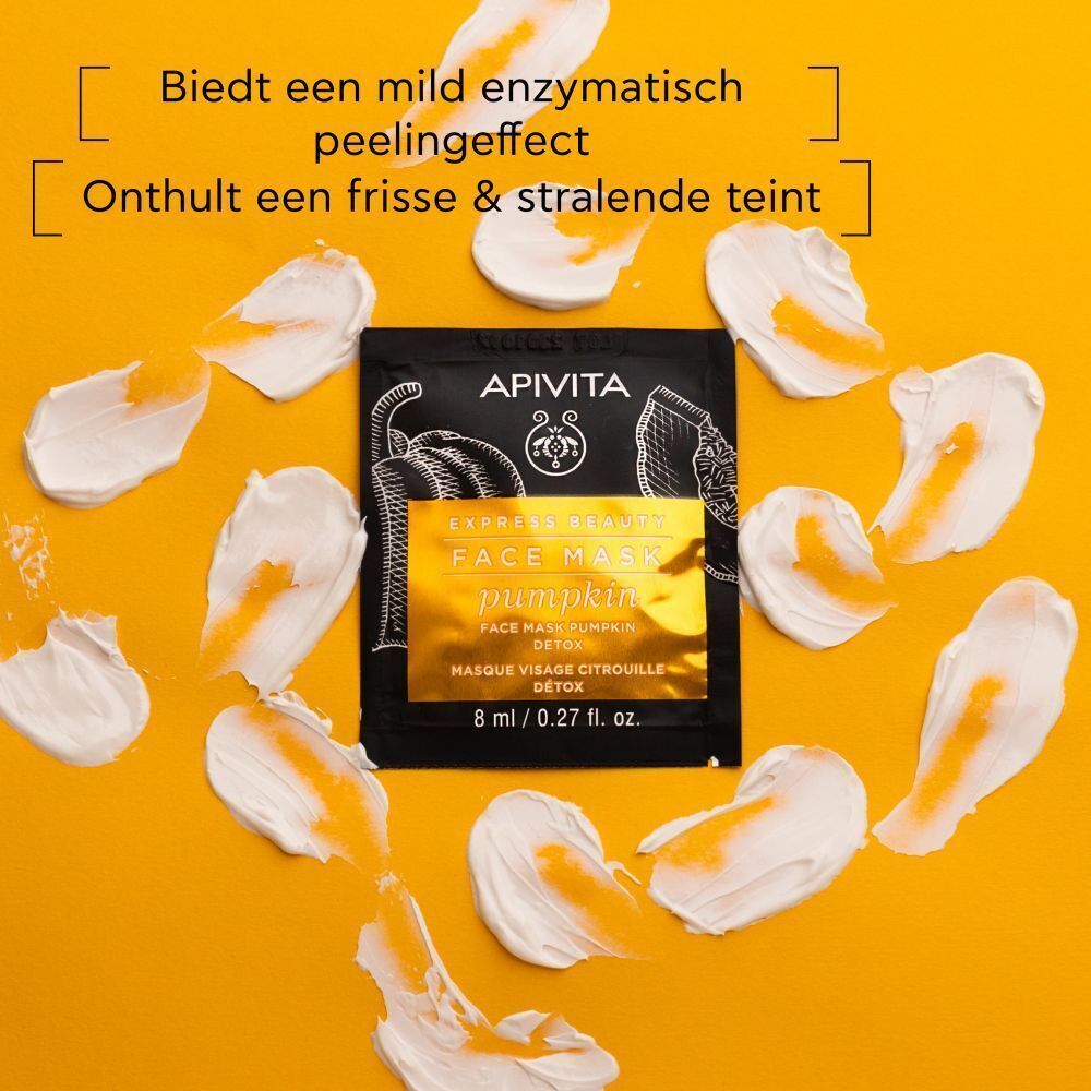 Apivita Gezichtsmasker Pompoen Detox, omringd door crèmekloddertjes.