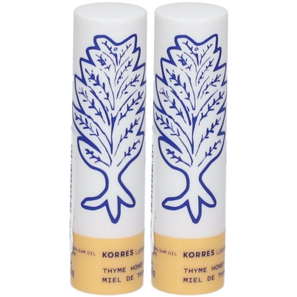 Deux baumes à lèvres Korres avec un design d'arbre bleu et une bande jaune.