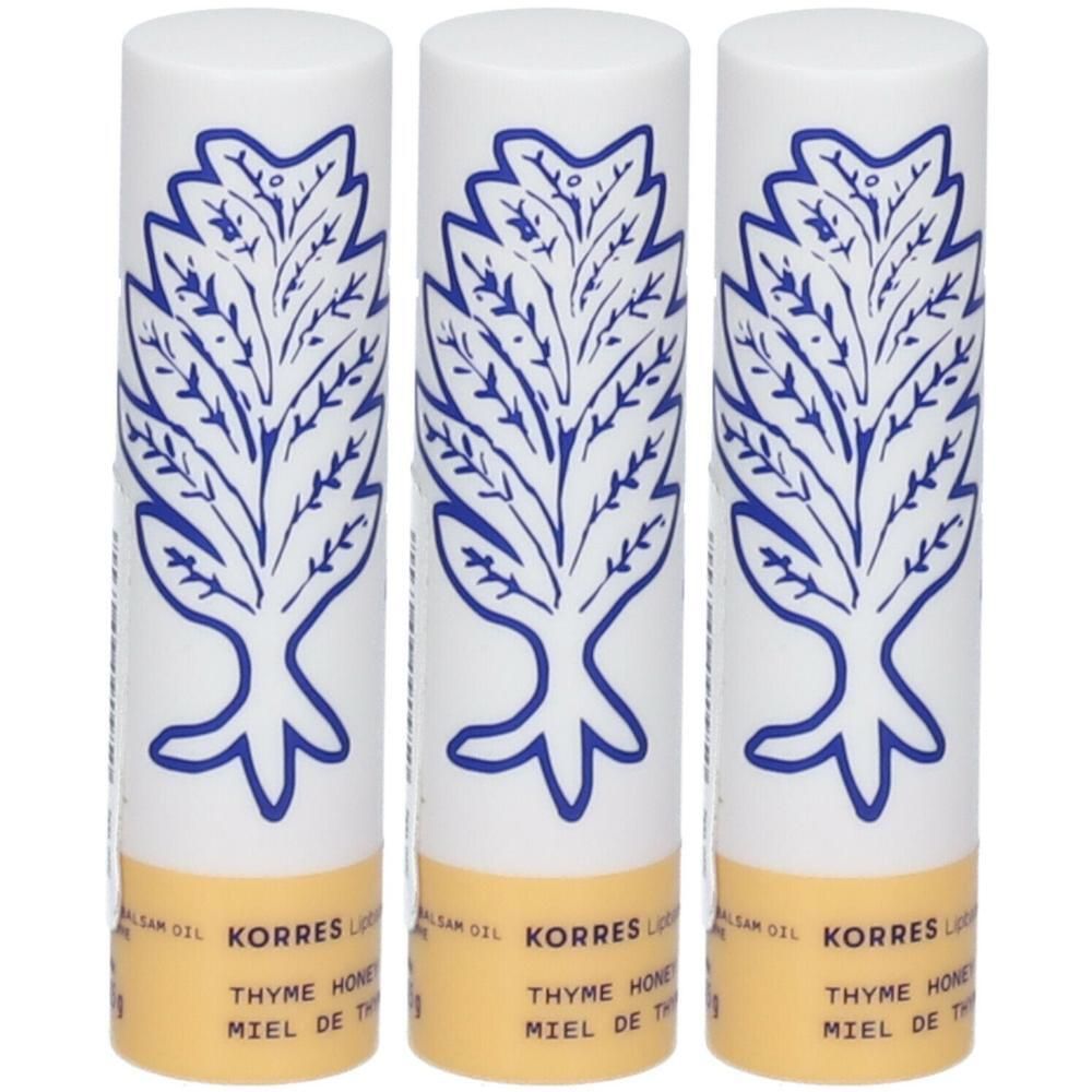 Trois baumes à lèvres Korres avec un design d'arbre bleu et une bande jaune.