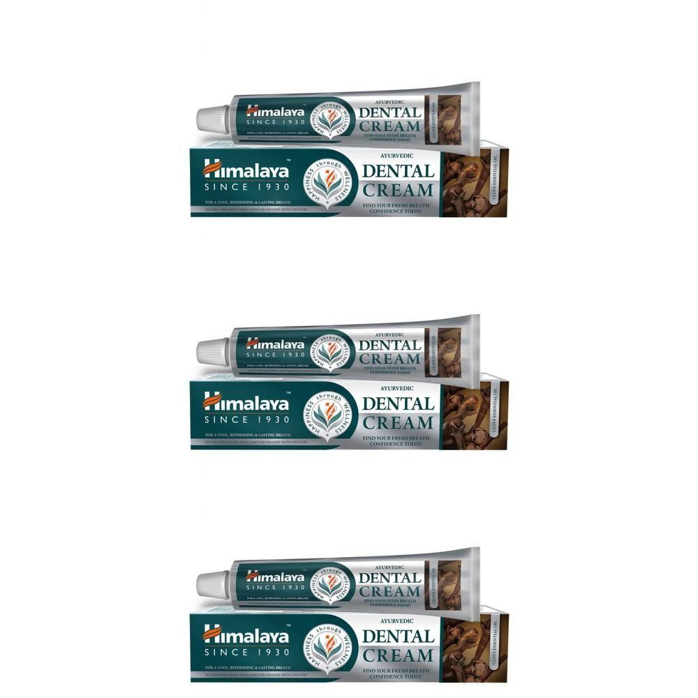 Drie tubes Himalaya Dental Cream met kruiden. De verpakking toont de merknaam en "Dental Cream".