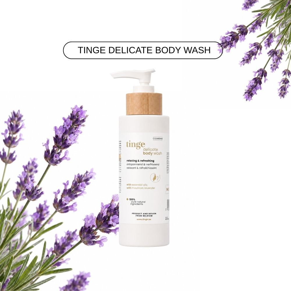 Fles Tinge Delicate Body Wash met pompdosering en houten dop, omringd door lavendel.