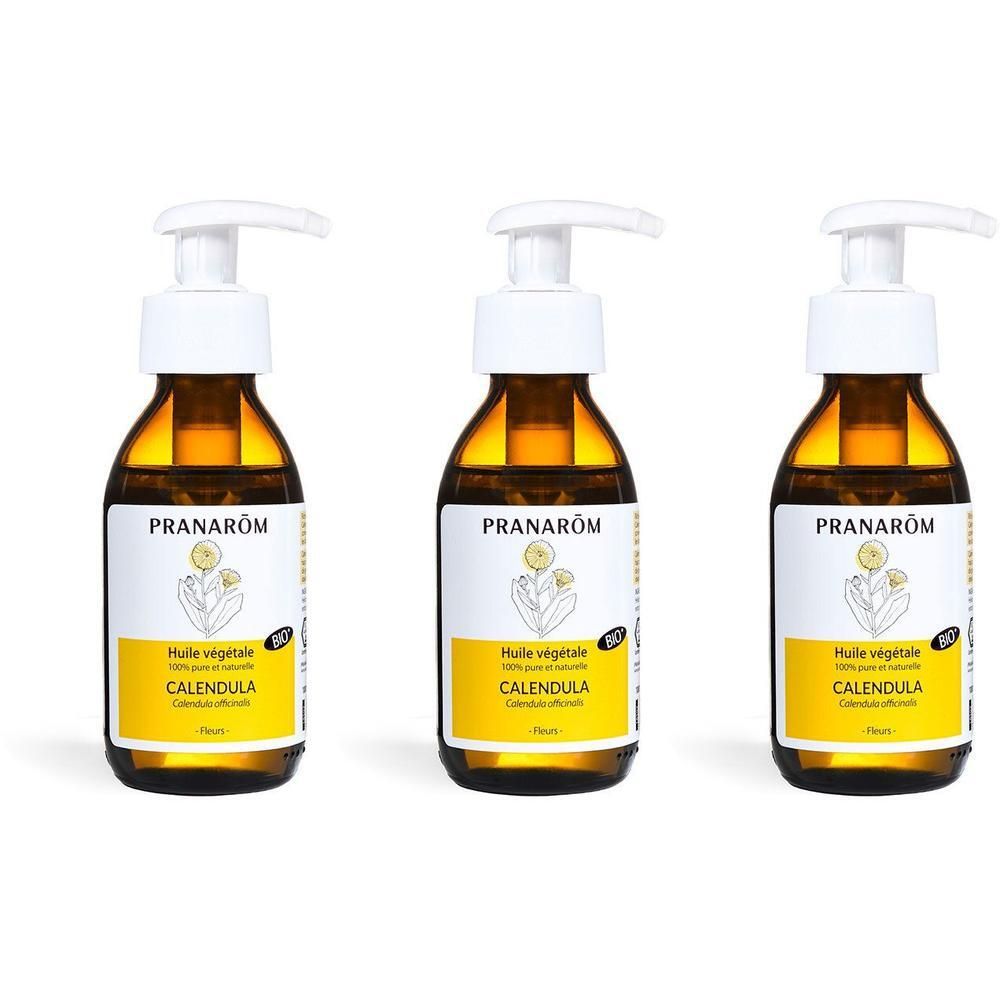 Trois flacons en verre brun avec distributeurs à pompe, contenant de l'Huile Végétale Calendula Bio Pranarôm.