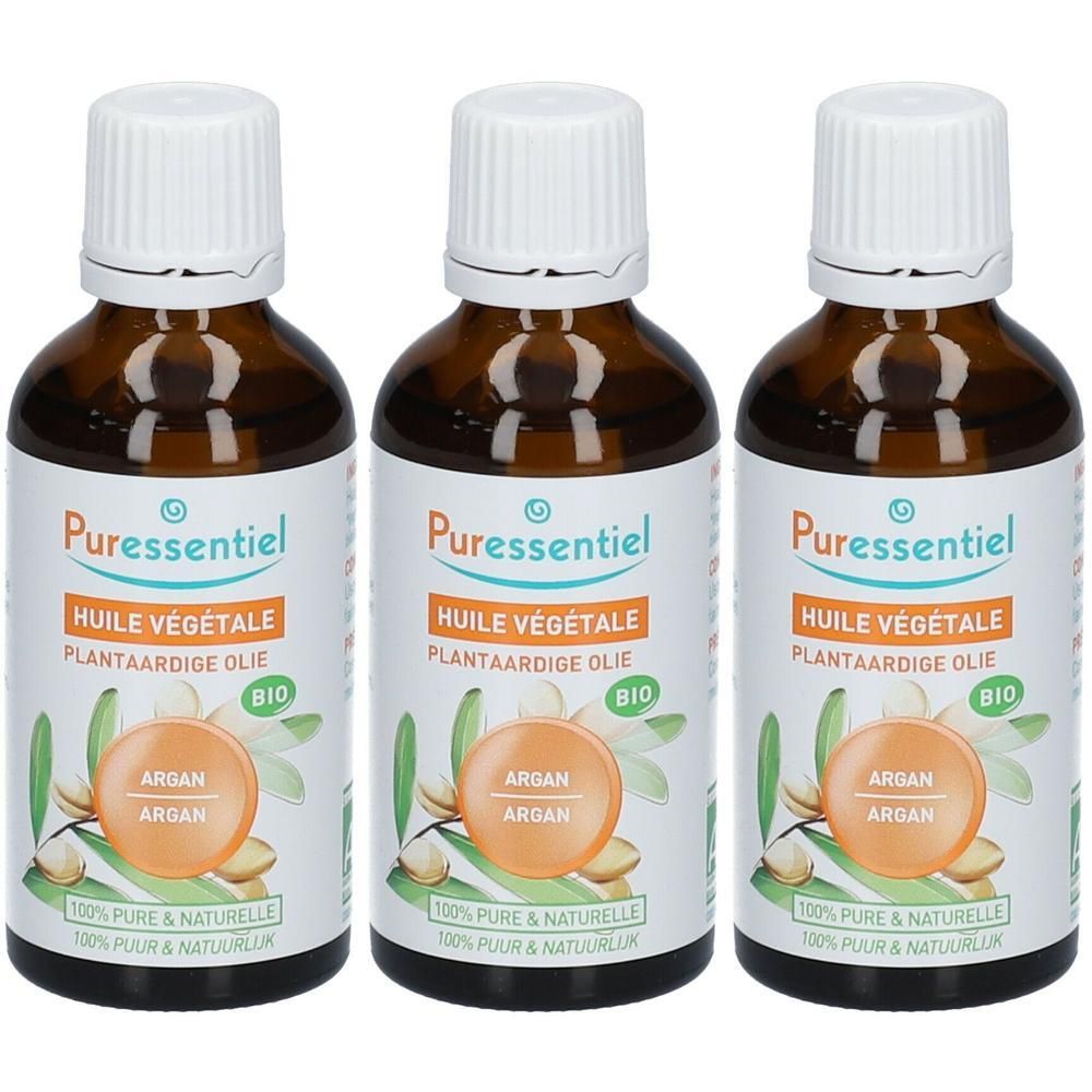 Trois flacons d'huile végétale bio Argan Puressentiel. Flacons en verre brun avec bouchons et étiquettes blancs.
