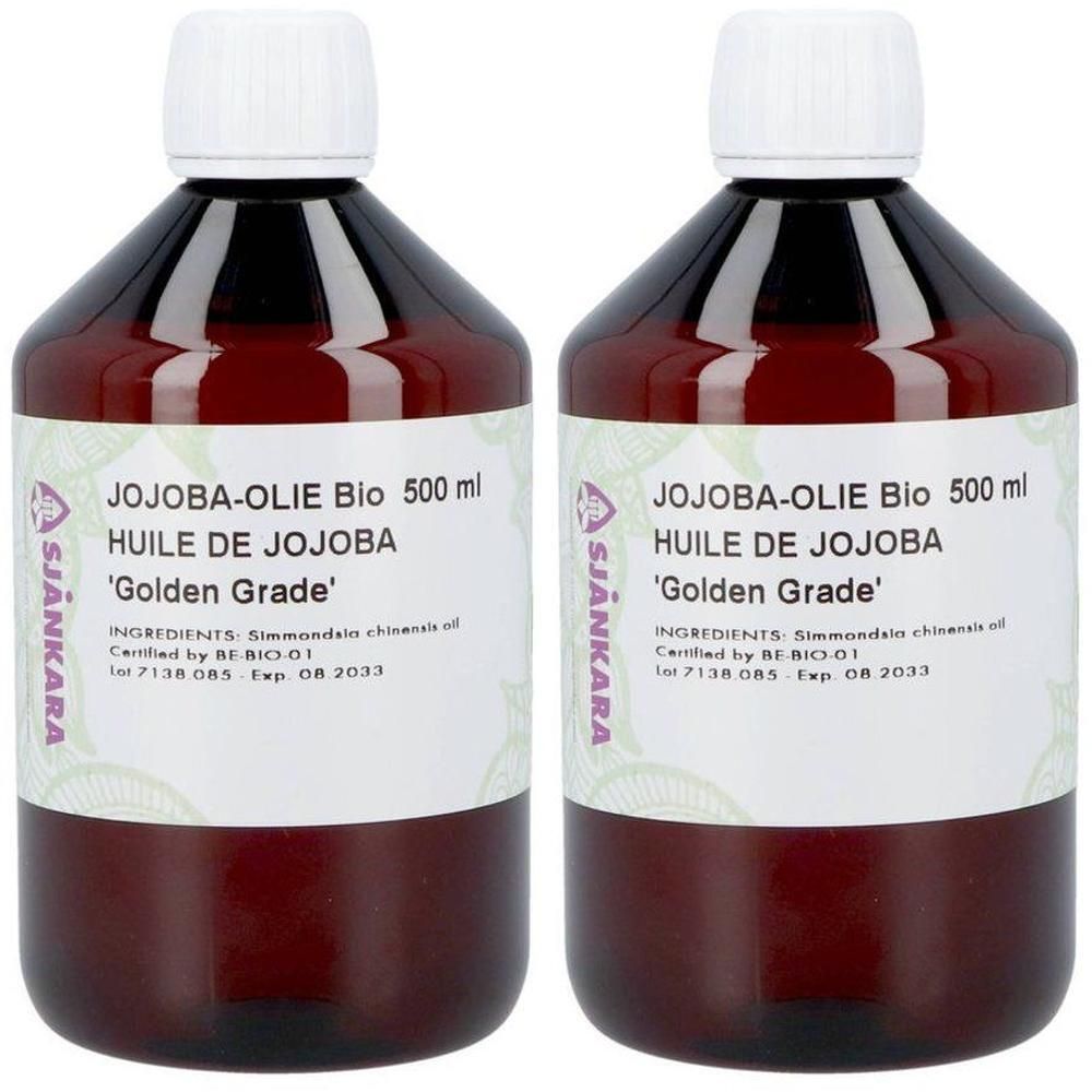 Deux bouteilles d'huile de jojoba bio 500 ml 'Golden Grade'. Bouteilles en verre brun avec bouchon blanc.