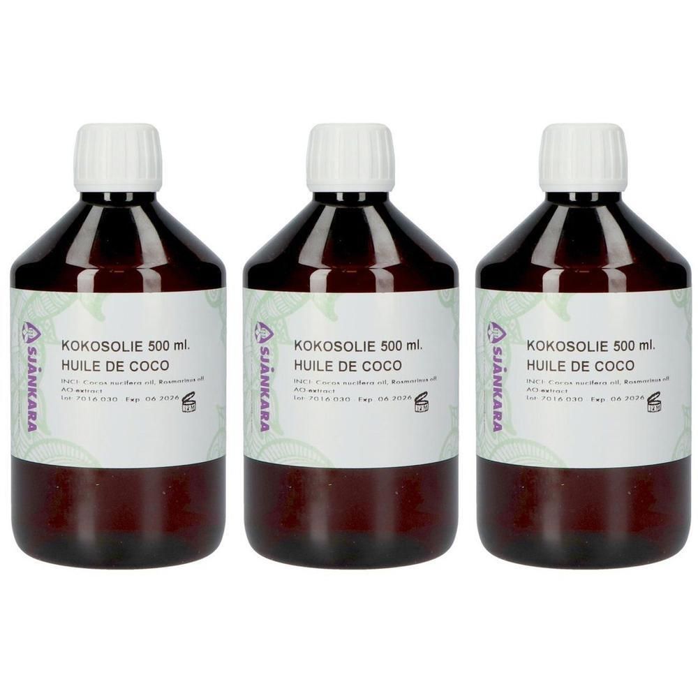 Trois bouteilles en verre ambré contenant de l'huile de coco de 500 ml.