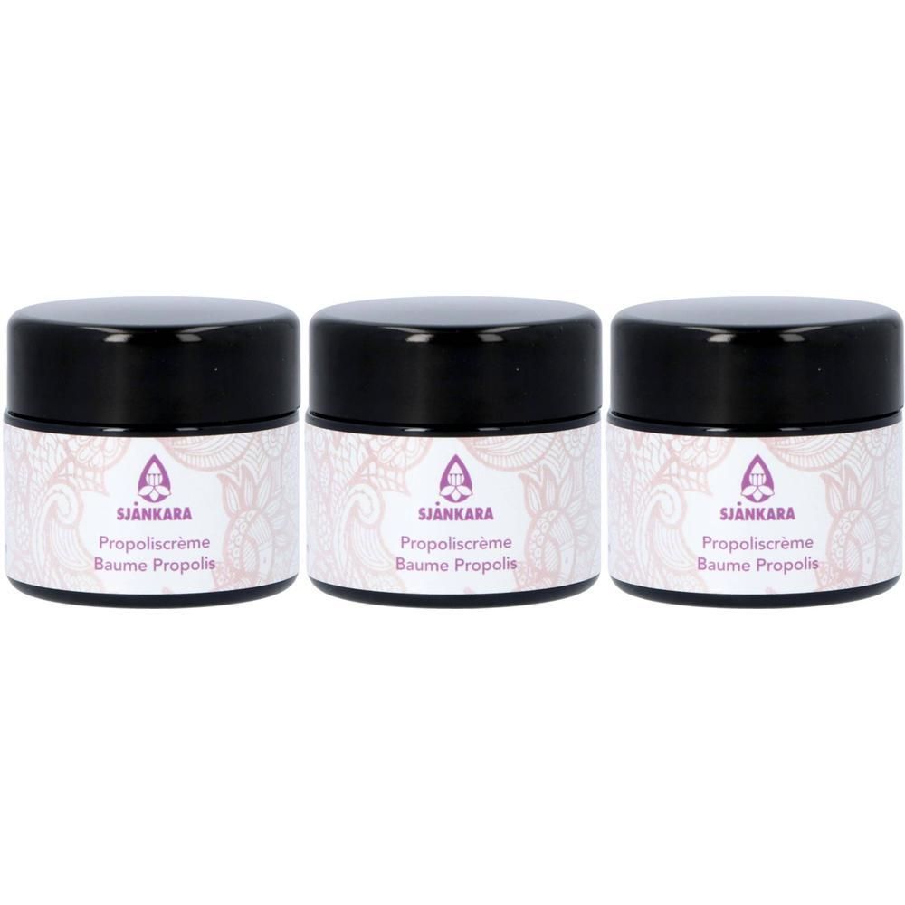 Trois pots de Baume Propolis Sjankara avec couvercles noirs et étiquette florale.