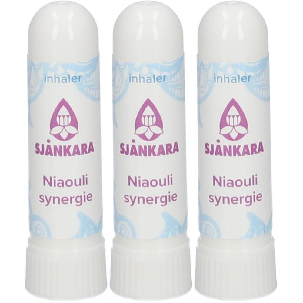 Drie witte inhalatoren met paars lotus-symbool en tekst 'Sjankara Niaouli synergie'.