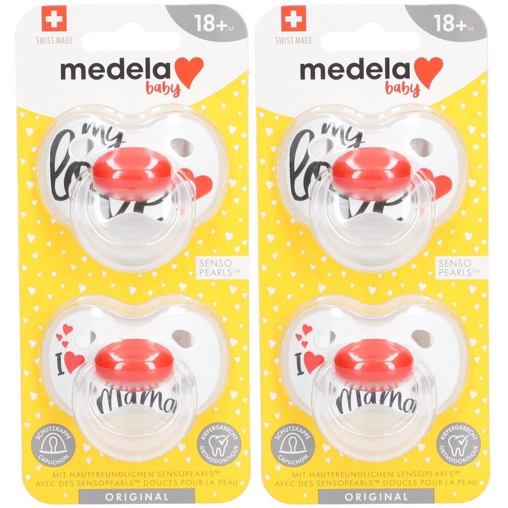 Deux sucettes Medela Original Signature Love Duo, 18+ mois, avec capuchon rouge et design cœur.