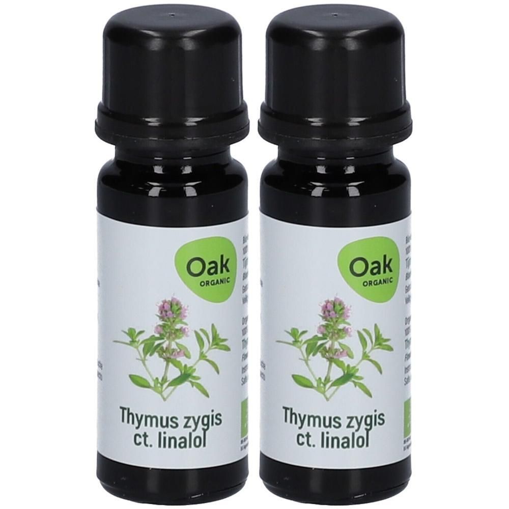 Twee flesjes Oak Biologische Tijm ct. linalol etherische olie met plantafbeelding.