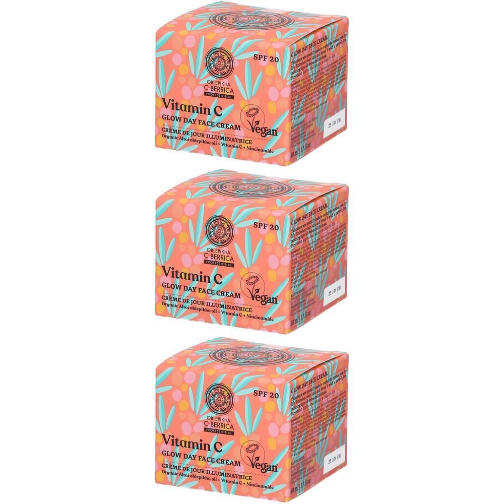 Trois boîtes de crème de jour visage Vitamine C SPF 20. L'emballage est décoré de feuilles et de baies.