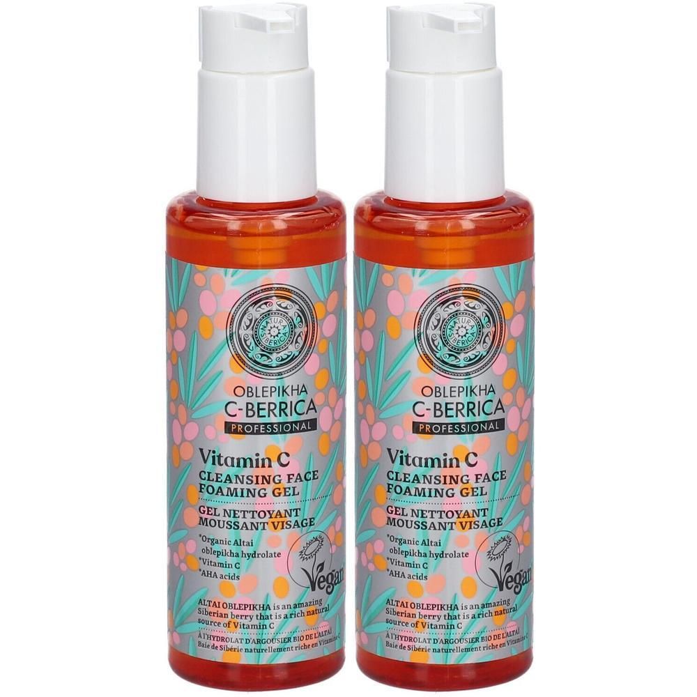 Twee flessen vitamine C reinigende gezichtsgel met pompdop en etiketten met plantenpatroon.