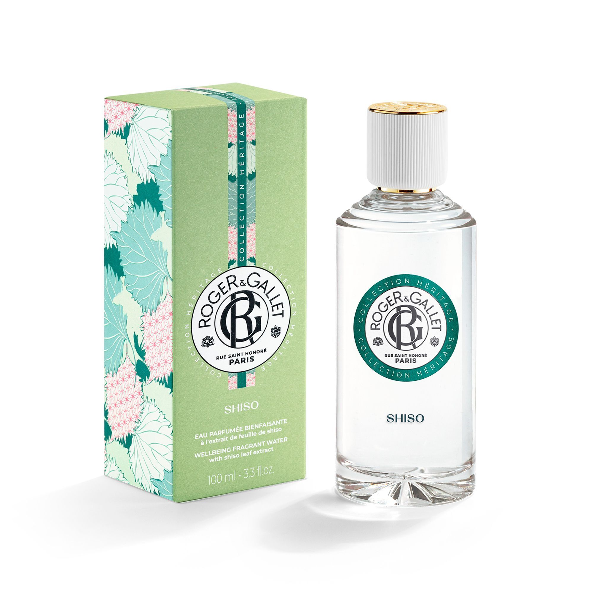 Un flacon de Roger & Gallet Eau Parfumée Bienfaisante SHISO à côté d'une boîte cadeau verte assortie à motif floral.