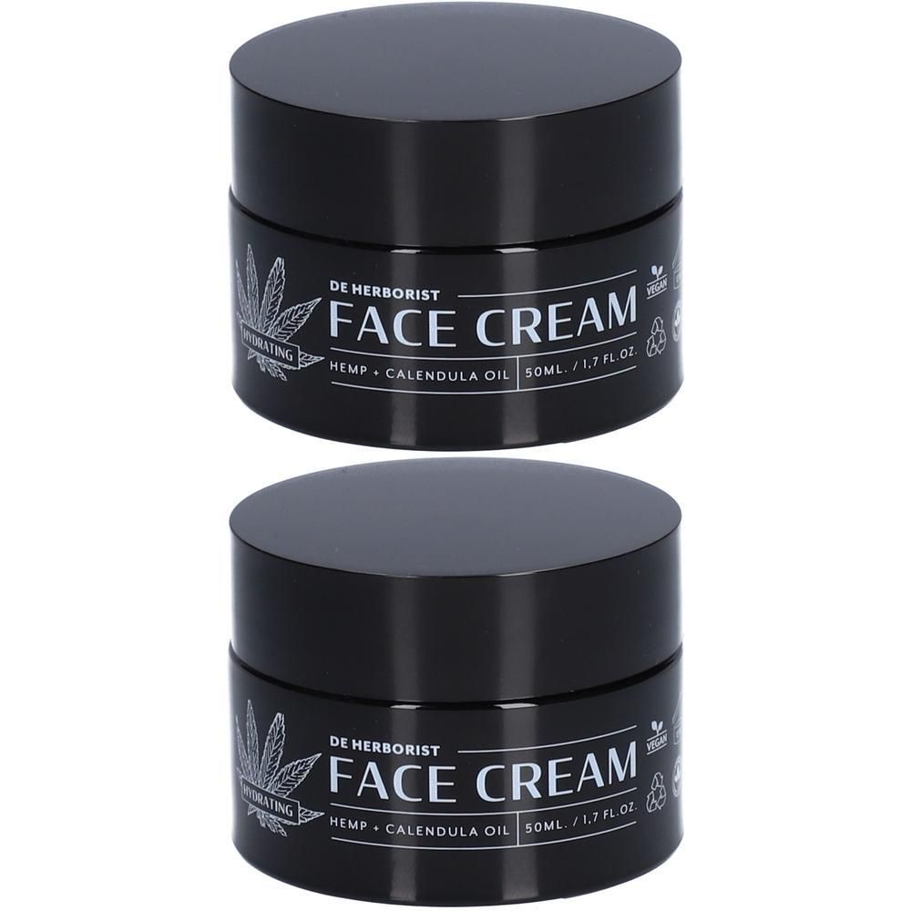 Deux pots noirs de crème visage au chanvre et à l'huile de calendula.