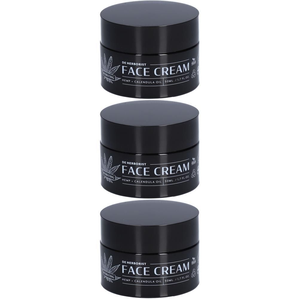 Drie zwarte potjes gezichtscreme met hennep en calendula. Etiket met 'Face Cream'.
