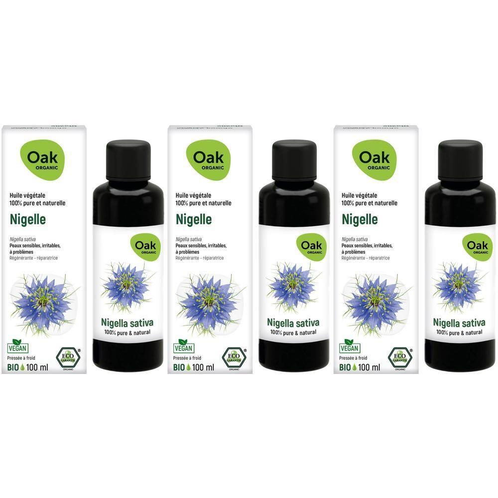 Oak Huile végétale Nigelle: Quatre flacons d'huile noire et leurs boîtes. Fleur de Nigella sativa représentée.