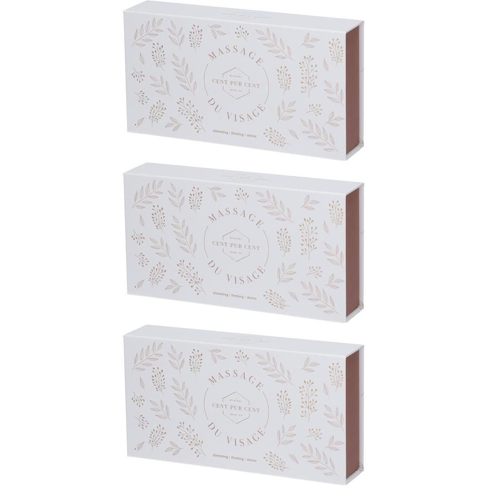 Trois boîtes cadeaux blanches ornées d'un motif floral et de l'inscription 'Massage du Visage'.