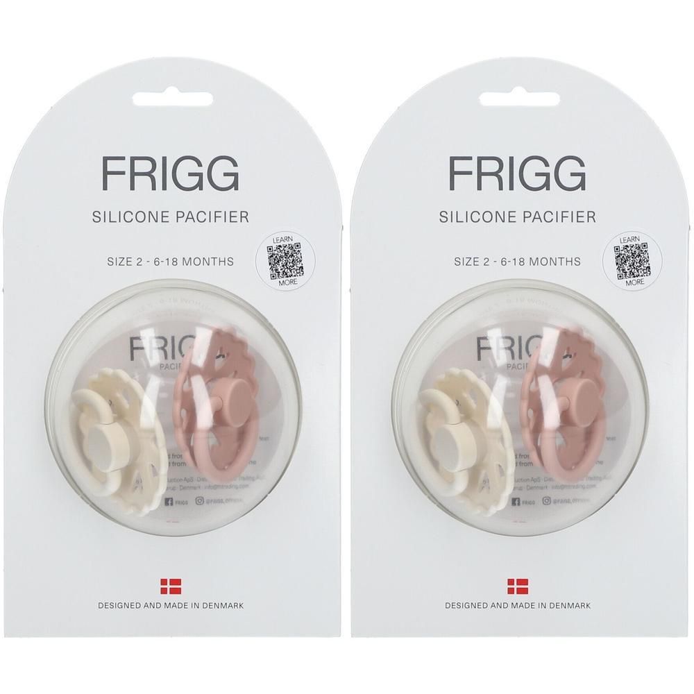 Twee FRIGG siliconen fopspenen, roze en beige, maat 2-6-18 maanden, in individuele verpakking.