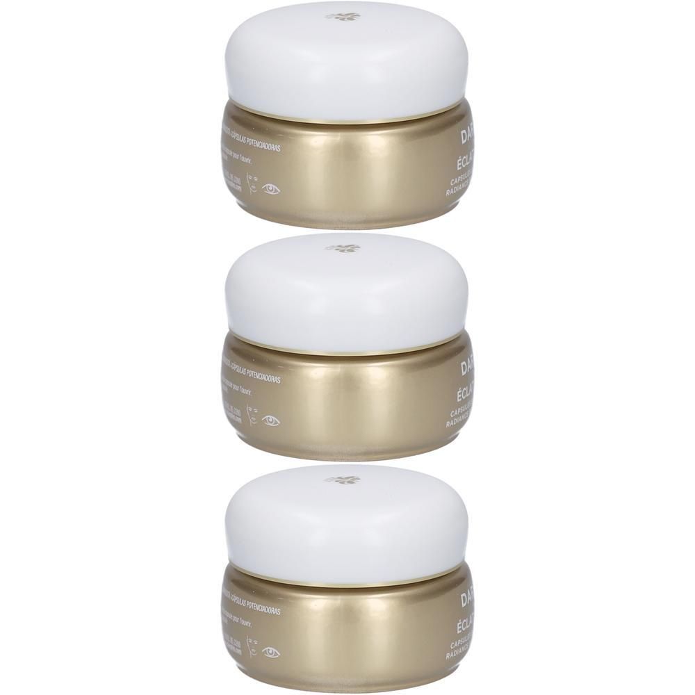 Trois pots dorés avec couvercles blancs, empilés.
