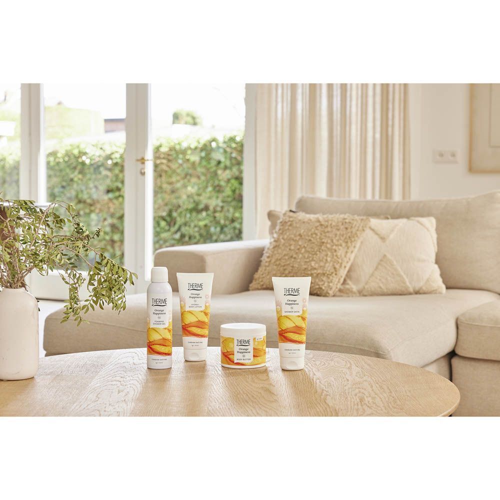 Therme Orange Happiness producten op een tafel voor een bank.
