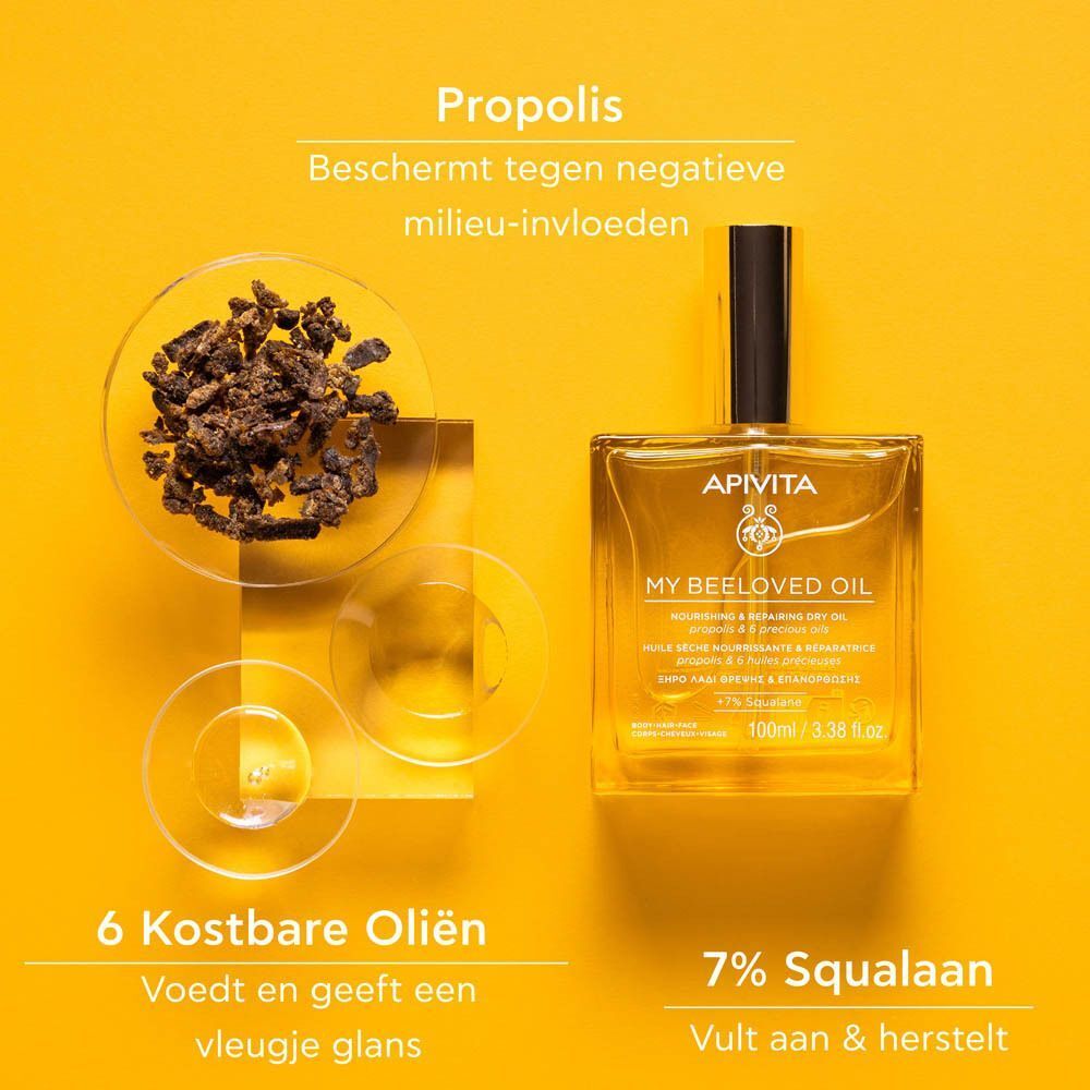 Fles Apivita My Beeloved Oil naast propoliskorrels en 6 kostbare oliën.